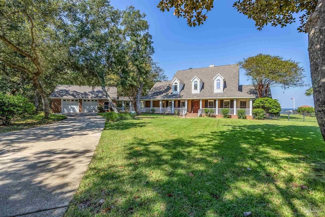 cape cod-style house with a front yard, covered porch, and a garage