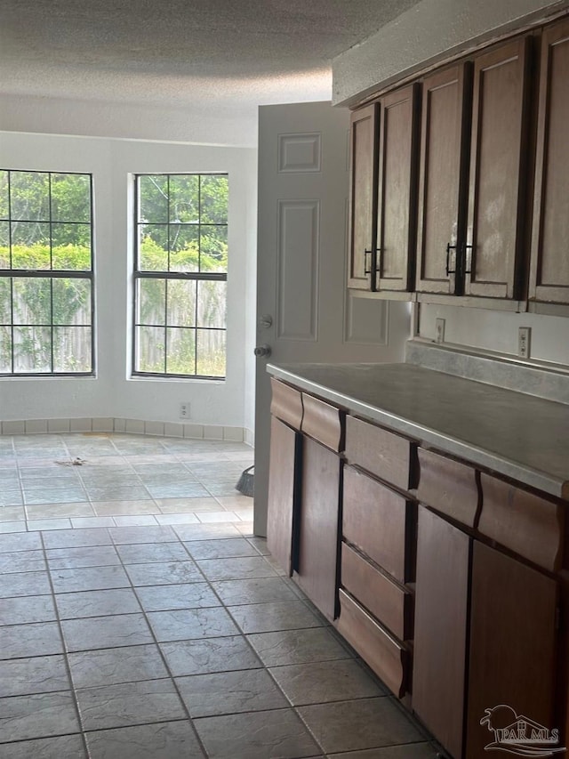 204 Chaseville St, Pensacola, FL 32507 - kitchen featuring a textured ceiling and baseboards