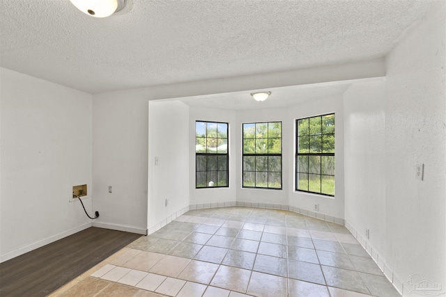 204 Chaseville St, Pensacola, FL 32507 - unfurnished room with a textured ceiling, light tile patterned floors, and baseboards