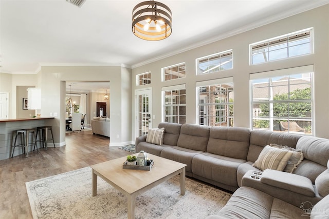 4282 Walden Way, Gulf Breeze, FL 32563 - living room featuring a chandelier, ornamental molding, light wood-style floors, and plenty of natural light
