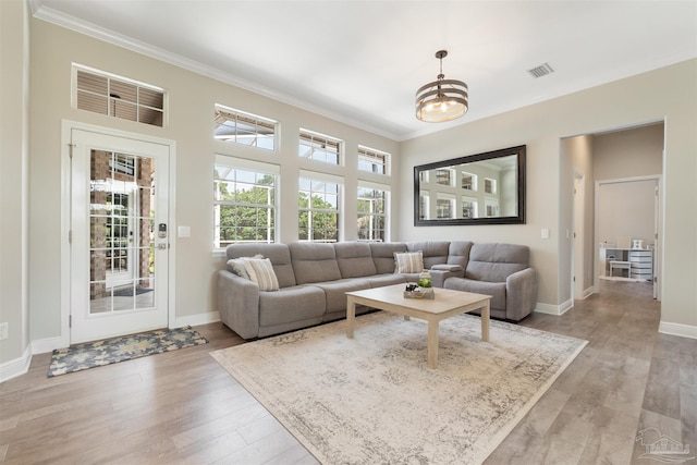 4282 Walden Way, Gulf Breeze, FL 32563 - living room featuring ornamental molding, light wood finished floors, baseboards, and a chandelier