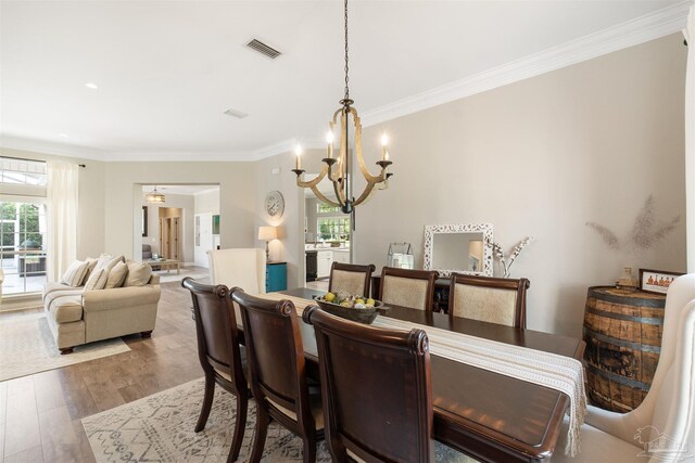 4282 Walden Way, Gulf Breeze, FL 32563 - dining area featuring a chandelier, ornamental molding, and wood finished floors