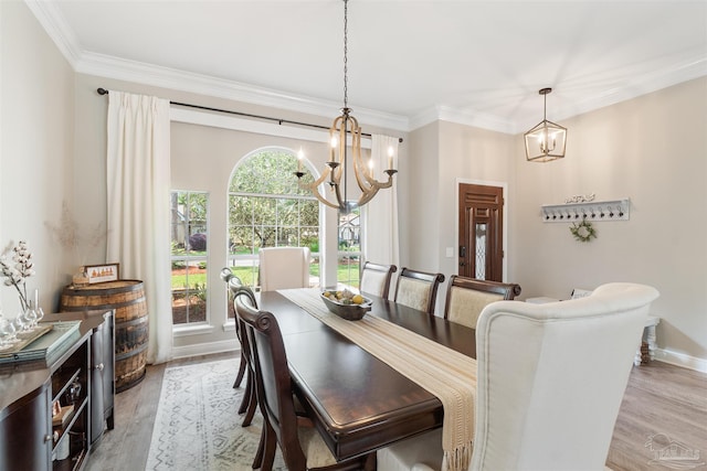 4282 Walden Way, Gulf Breeze, FL 32563 - dining space with a chandelier, light wood finished floors, crown molding, and baseboards