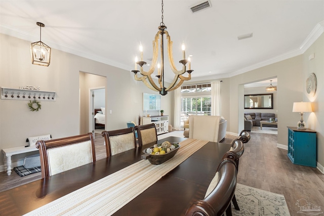 4282 Walden Way, Gulf Breeze, FL 32563 - dining space with a chandelier, wood finished floors, crown molding, and baseboards