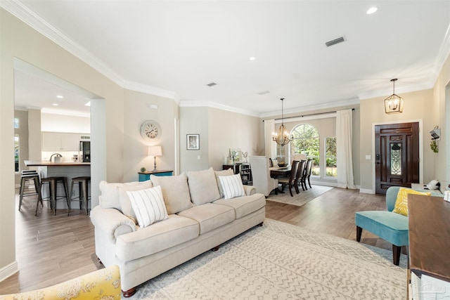 4282 Walden Way, Gulf Breeze, FL 32563 - living area featuring wood finished floors, a chandelier, crown molding, baseboards, and recessed lighting