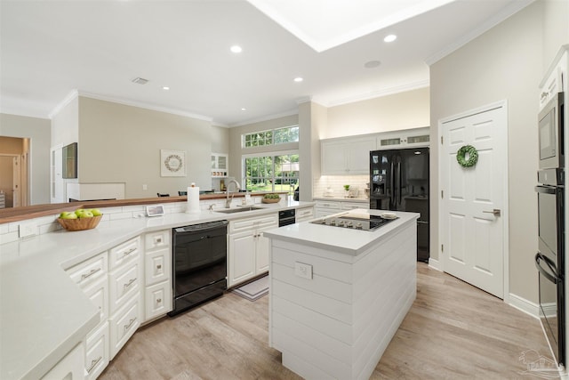 4282 Walden Way, Gulf Breeze, FL 32563 - kitchen with black appliances, a sink, light wood-style floors, a kitchen island, and recessed lighting