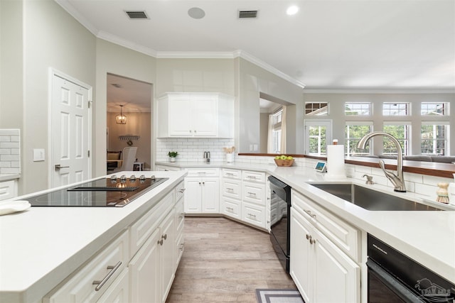 4282 Walden Way, Gulf Breeze, FL 32563 - kitchen featuring a sink, black appliances, decorative backsplash, light wood finished floors, and crown molding