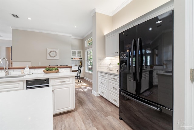 4282 Walden Way, Gulf Breeze, FL 32563 - kitchen featuring black fridge with ice dispenser, crown molding, light wood finished floors, backsplash, and light countertops