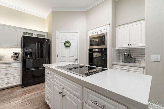 4282 Walden Way, Gulf Breeze, FL 32563 - kitchen with black appliances, decorative backsplash, ornamental molding, white cabinetry, and light wood-style floors