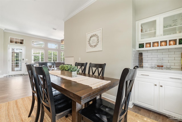 4282 Walden Way, Gulf Breeze, FL 32563 - dining space with ornamental molding, wood finished floors, baseboards, and a chandelier