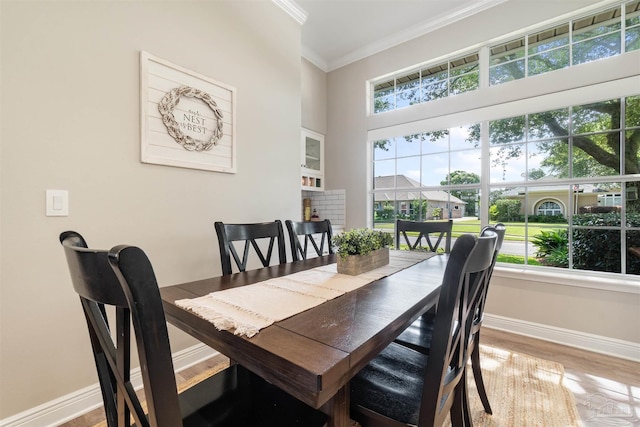 4282 Walden Way, Gulf Breeze, FL 32563 - dining area featuring ornamental molding, baseboards, plenty of natural light, light wood-style floors, and a high ceiling