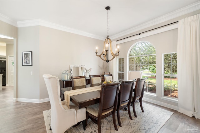 4282 Walden Way, Gulf Breeze, FL 32563 - dining space with crown molding, a chandelier, light wood-style floors, and baseboards