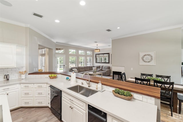 4282 Walden Way, Gulf Breeze, FL 32563 - kitchen with a sink, black dishwasher, crown molding, light wood-style flooring, and recessed lighting