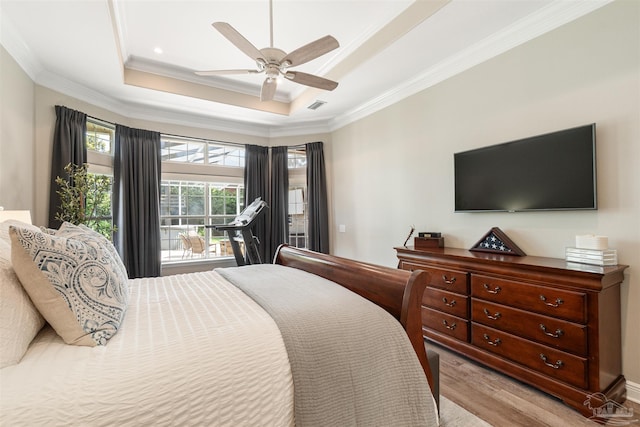4282 Walden Way, Gulf Breeze, FL 32563 - bedroom with light wood finished floors, ornamental molding, a tray ceiling, and a ceiling fan