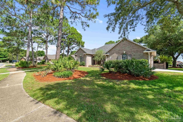 4282 Walden Way, Gulf Breeze, FL 32563 - view of front of property featuring brick siding and a front lawn
