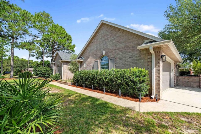 4282 Walden Way, Gulf Breeze, FL 32563 - view of side of home with concrete driveway, an attached garage, brick siding, and stone siding