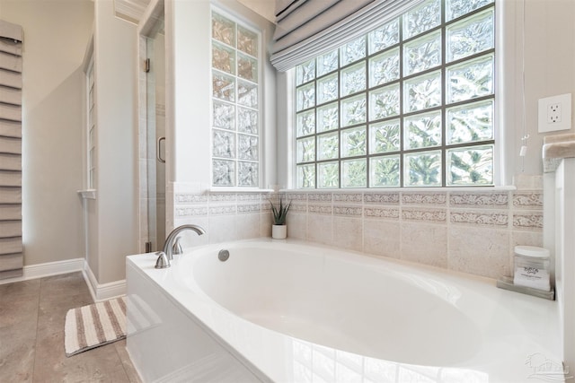 4282 Walden Way, Gulf Breeze, FL 32563 - bathroom with healthy amount of natural light, a garden tub, a shower stall, and tile patterned flooring