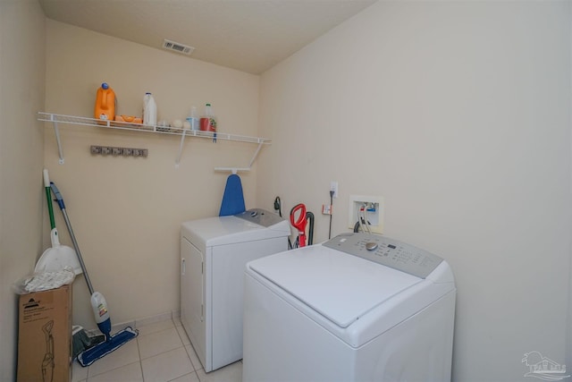 laundry room with light tile patterned floors and washer and dryer