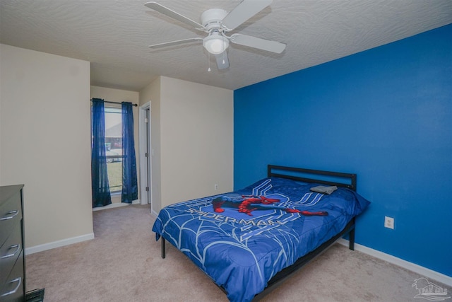 bedroom with a textured ceiling, ceiling fan, and light colored carpet