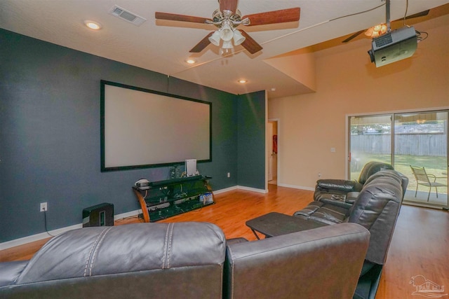 cinema featuring ceiling fan and wood-type flooring