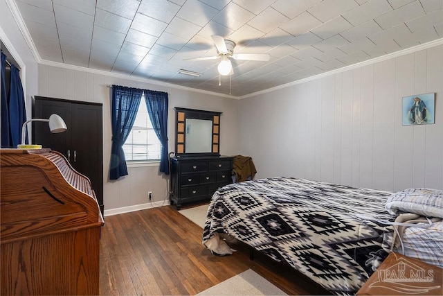 bedroom featuring crown molding, ceiling fan, and wood-type flooring