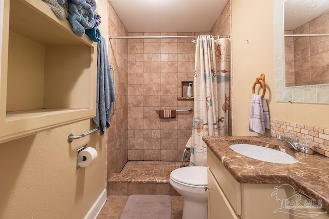 bathroom with a shower with shower curtain, vanity, tile patterned flooring, and toilet