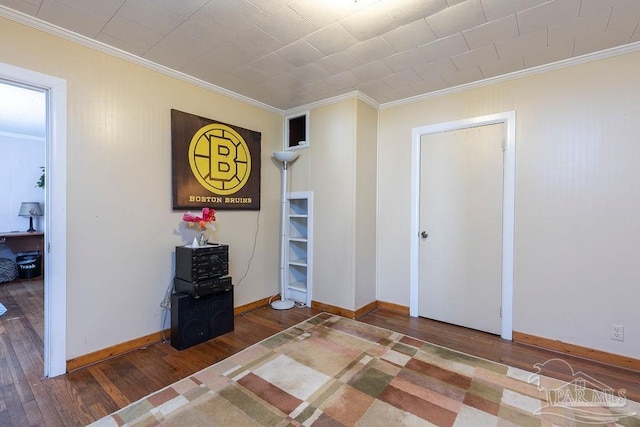 unfurnished bedroom featuring hardwood / wood-style flooring and ornamental molding