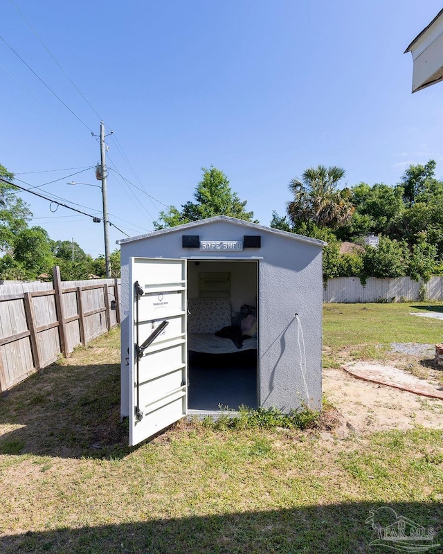 view of outbuilding featuring a lawn