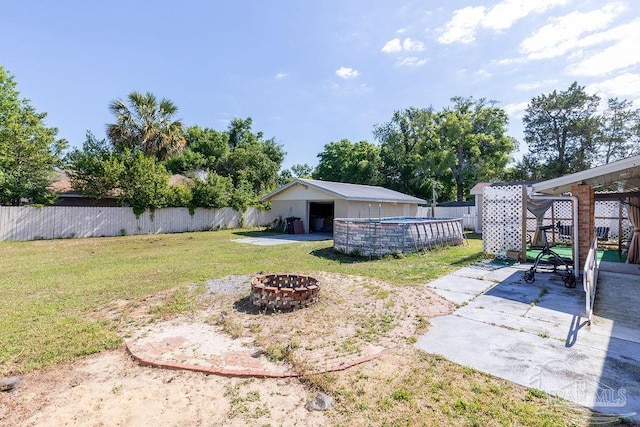 view of yard with an outdoor fire pit, a gazebo, a patio area, and a fenced in pool