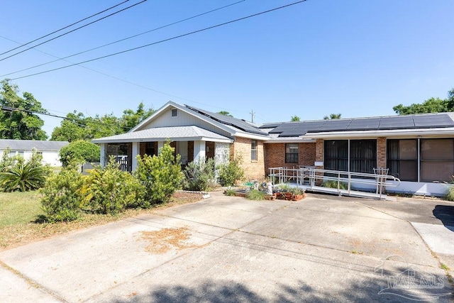 ranch-style home with solar panels