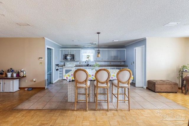 kitchen featuring hanging light fixtures, white electric range, light parquet flooring, and gray cabinets