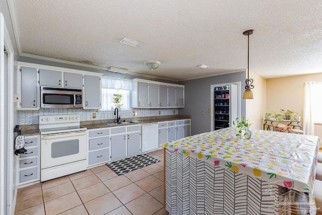 kitchen with white appliances, gray cabinetry, sink, backsplash, and decorative light fixtures