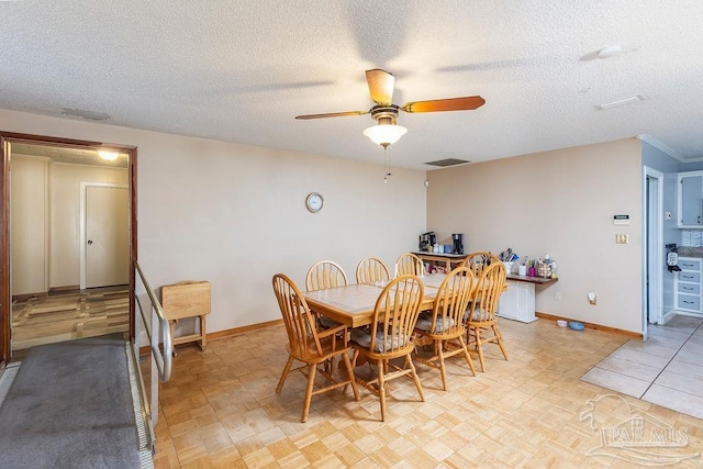 dining area featuring light tile patterned flooring, a textured ceiling, and ceiling fan