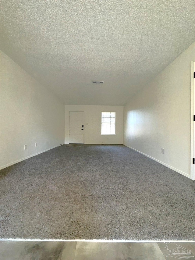 unfurnished room with a textured ceiling