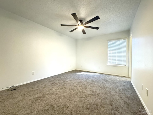 carpeted spare room featuring ceiling fan and a textured ceiling