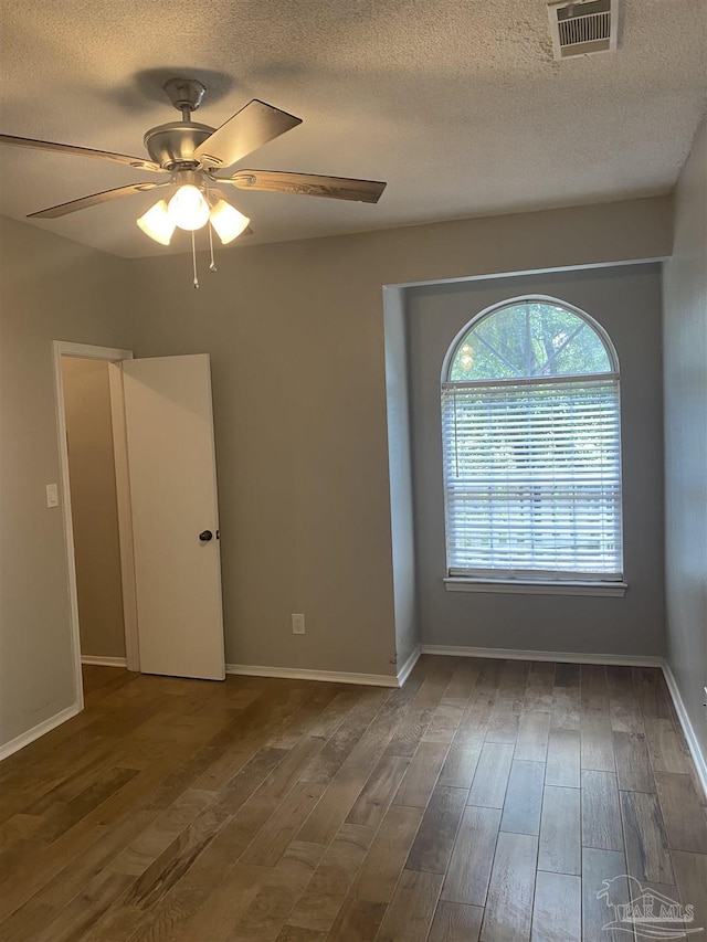 unfurnished room featuring hardwood / wood-style flooring, a textured ceiling, and ceiling fan