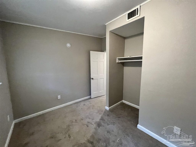 unfurnished bedroom with a closet, visible vents, and baseboards