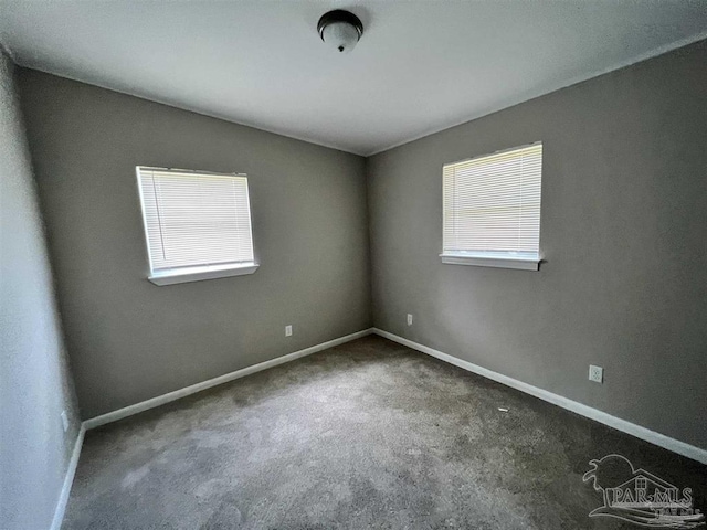 spare room with carpet and baseboards