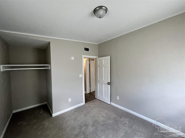 unfurnished bedroom featuring a closet, carpet flooring, visible vents, and baseboards