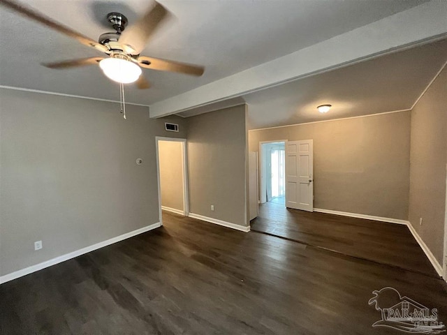 unfurnished room featuring visible vents, dark wood finished floors, and baseboards