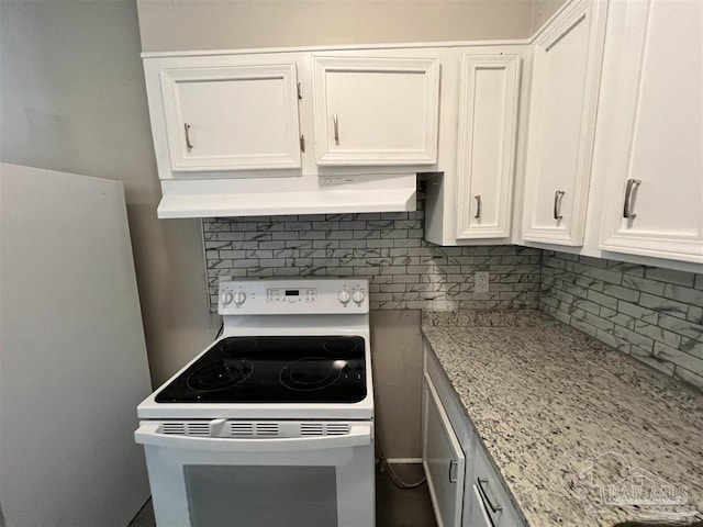 kitchen with freestanding refrigerator, white cabinets, decorative backsplash, and white range with electric cooktop