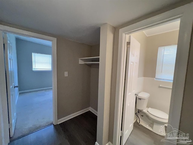 bathroom with baseboards and toilet