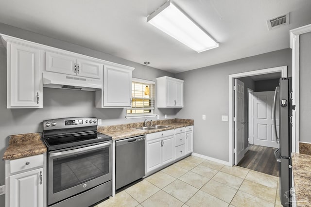 333 Western Pine Rd, Cantonment, FL 32533 - kitchen featuring white cabinets, a sink, visible vents, under cabinet range hood, and appliances with stainless steel finishes