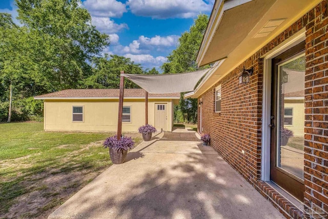 333 Western Pine Rd, Cantonment, FL 32533 - view of side of property featuring a lawn, brick siding, and a patio area