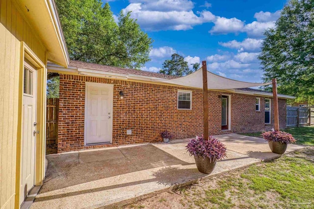 333 Western Pine Rd, Cantonment, FL 32533 - back of house with brick siding, fence, and a patio area