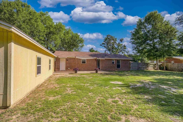 333 Western Pine Rd, Cantonment, FL 32533 - back of property featuring a lawn, fence, and a patio area