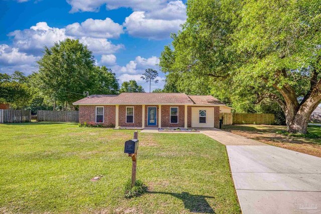 333 Western Pine Rd, Cantonment, FL 32533 - ranch-style home featuring fence, driveway, brick siding, and a front yard