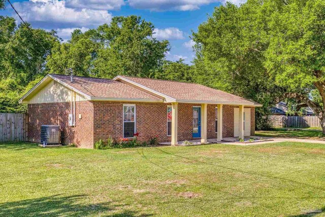 333 Western Pine Rd, Cantonment, FL 32533 - ranch-style house with brick siding, central air condition unit, a front lawn, and fence