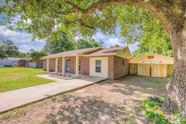333 Western Pine Rd, Cantonment, FL 32533 - single story home with brick siding, a front lawn, fence, and a patio