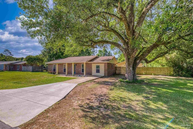 333 Western Pine Rd, Cantonment, FL 32533 - single story home featuring brick siding, a front lawn, fence, and driveway